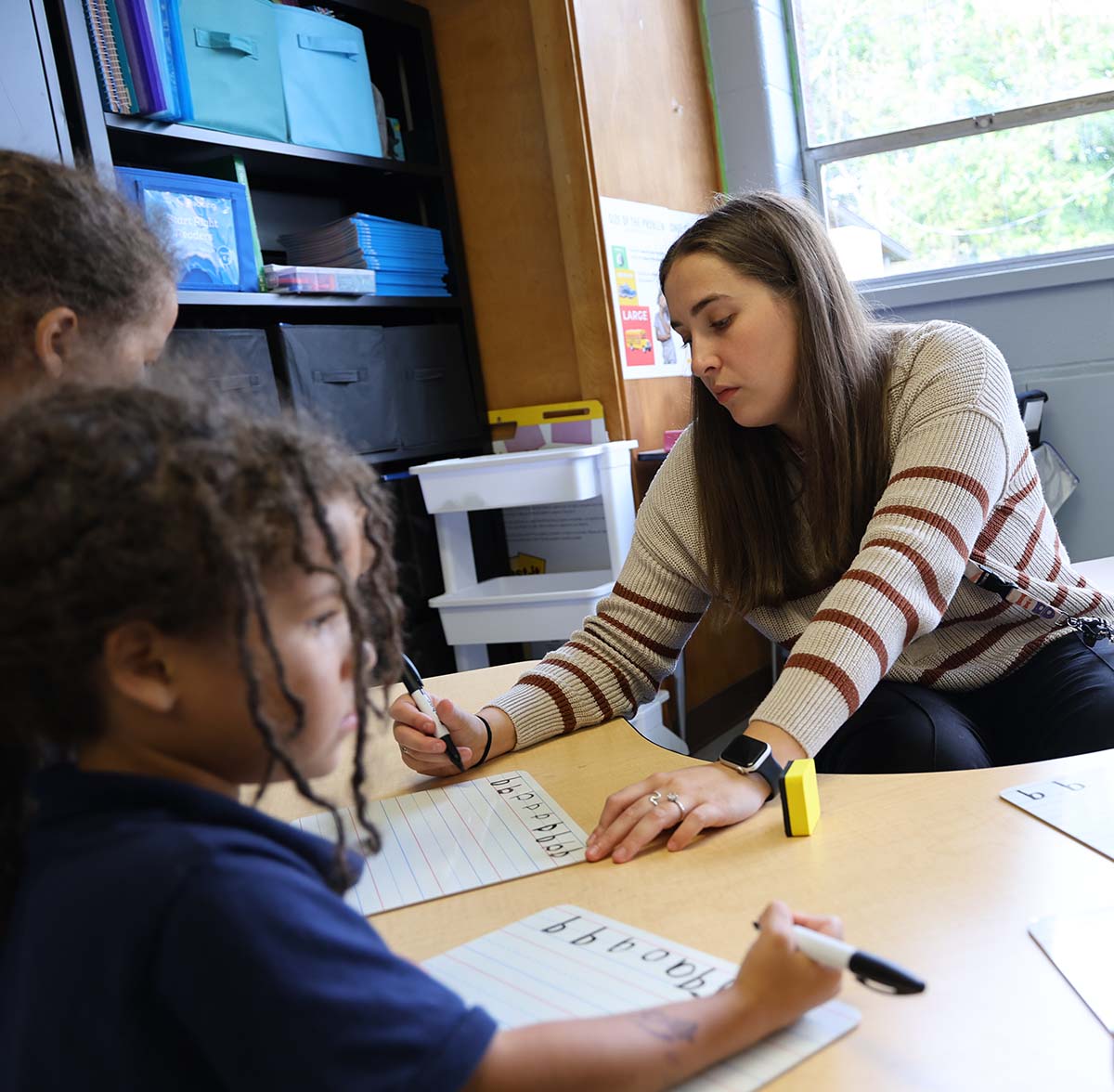 Horizon Science Academy Springfield North Teacher and student interacting at a classroom desk